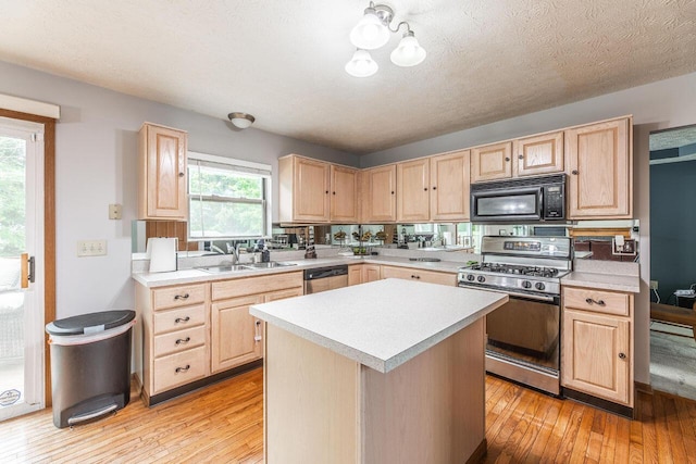 2643 Westrock Dr, Hilliard, OH 43026 - kitchen featuring light brown cabinetry, black microwave, gas range, a sink, and light countertops