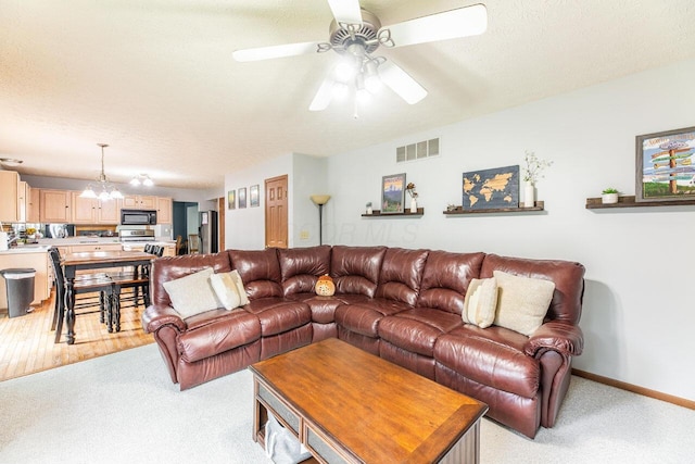 2643 Westrock Dr, Hilliard, OH 43026 - living room with light colored carpet, ceiling fan, baseboards, and a chandelier