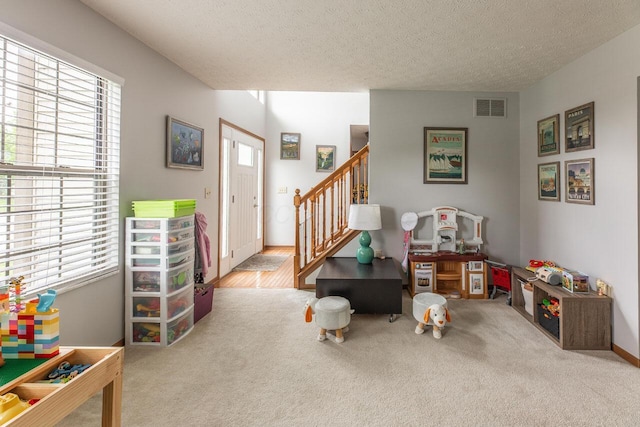 2643 Westrock Dr, Hilliard, OH 43026 - entrance foyer with plenty of natural light, stairs, carpet flooring, and a textured ceiling