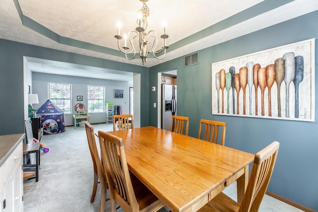 2643 Westrock Dr, Hilliard, OH 43026 - dining area featuring carpet flooring, a chandelier, a textured ceiling, and baseboards