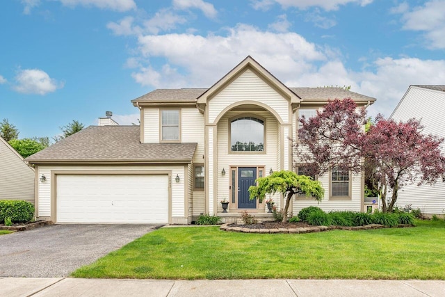 2643 Westrock Dr, Hilliard, OH 43026 - traditional-style home with asphalt driveway, an attached garage, a front lawn, and a shingled roof