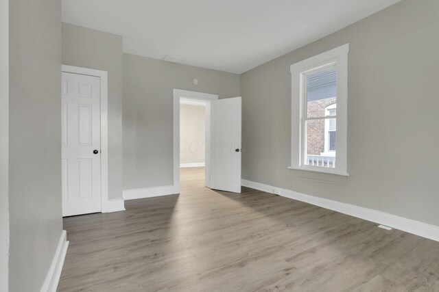358 Saint Clair Ave, Columbus, OH 43203 - unfurnished bedroom featuring wood finished floors and baseboards