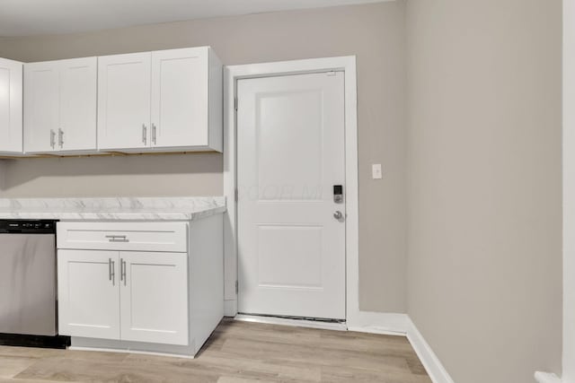 358 Saint Clair Ave, Columbus, OH 43203 - kitchen with stainless steel dishwasher, white cabinetry, light wood-style flooring, and light stone counters