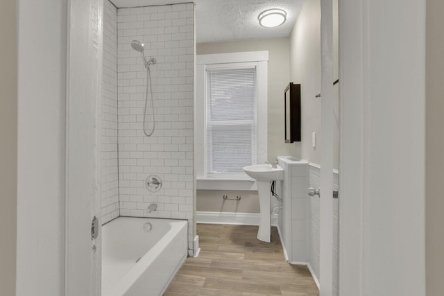 358 Saint Clair Ave, Columbus, OH 43203 - full bathroom featuring  shower combination, wood finished floors, and a textured ceiling