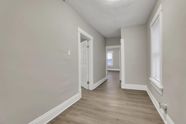 358 Saint Clair Ave, Columbus, OH 43203 - hall with baseboards, a textured ceiling, and light wood-type flooring