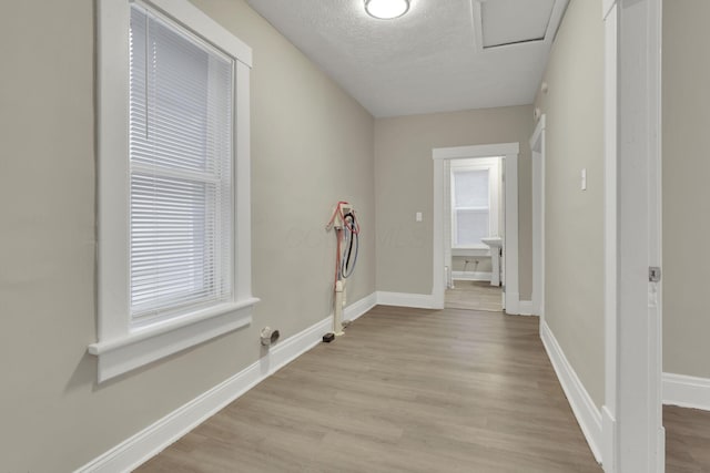358 Saint Clair Ave, Columbus, OH 43203 - laundry room featuring light wood finished floors, baseboards, a textured ceiling, and attic access