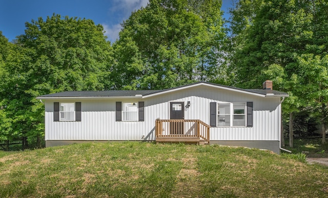 26 Crabtree Ct, Howard, OH 43028 - view of front of house with a front lawn, a chimney, and metal roof