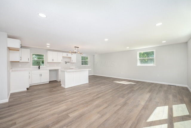 26 Crabtree Ct, Howard, OH 43028 - unfurnished living room with a chandelier, recessed lighting, a sink, baseboards, and light wood-style floors