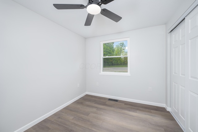 26 Crabtree Ct, Howard, OH 43028 - unfurnished bedroom with a closet, dark wood-style floors, baseboards, and a ceiling fan