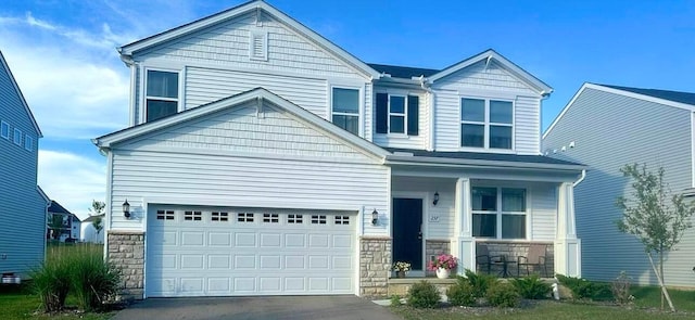 257 Whitetail Trl, Johnstown, OH 43031 - craftsman-style home with a porch, stone siding, driveway, and an attached garage