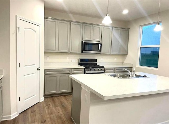 257 Whitetail Trl, Johnstown, OH 43031 - kitchen featuring stainless steel appliances, gray cabinetry, a sink, dark wood-style floors, and pendant lighting
