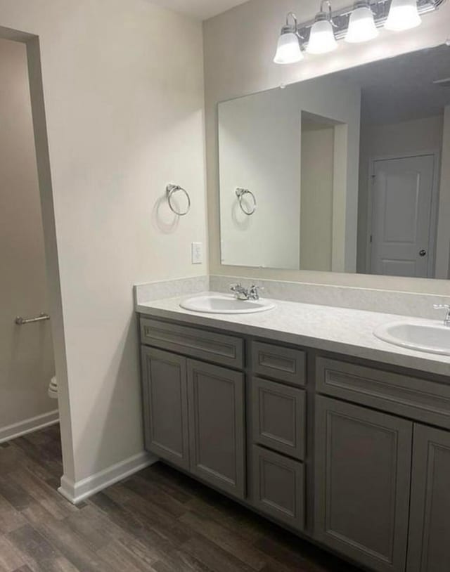257 Whitetail Trl, Johnstown, OH 43031 - bathroom with double vanity, toilet, wood finished floors, and baseboards