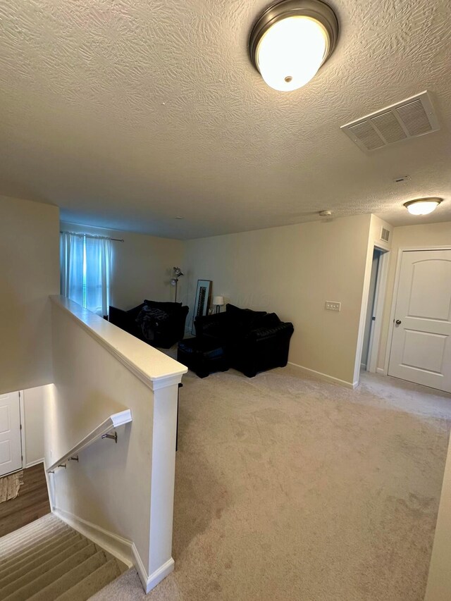 257 Whitetail Trl, Johnstown, OH 43031 - stairs featuring carpet flooring, a textured ceiling, and baseboards