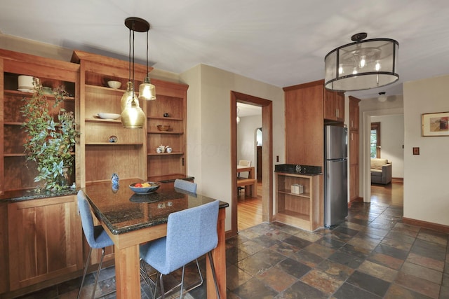 249 Blenheim Rd, Columbus, OH 43214 - dining area featuring baseboards and stone tile flooring