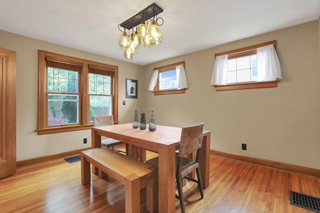 249 Blenheim Rd, Columbus, OH 43214 - dining room featuring baseboards, light wood-style flooring, and a chandelier