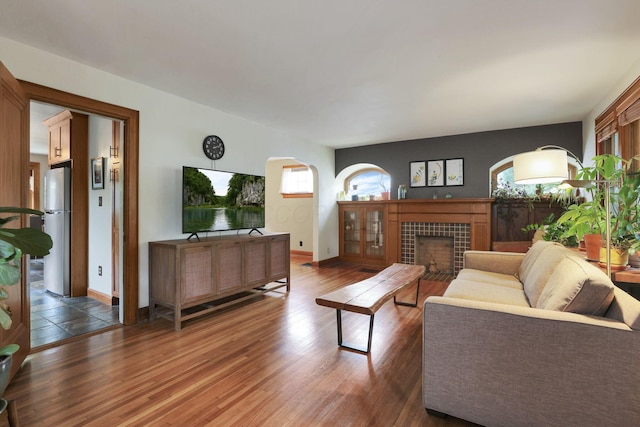 249 Blenheim Rd, Columbus, OH 43214 - living room featuring wood finished floors, a tile fireplace, and baseboards