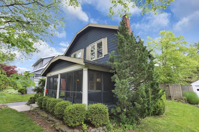 249 Blenheim Rd, Columbus, OH 43214 - view of property exterior with a sunroom and a chimney
