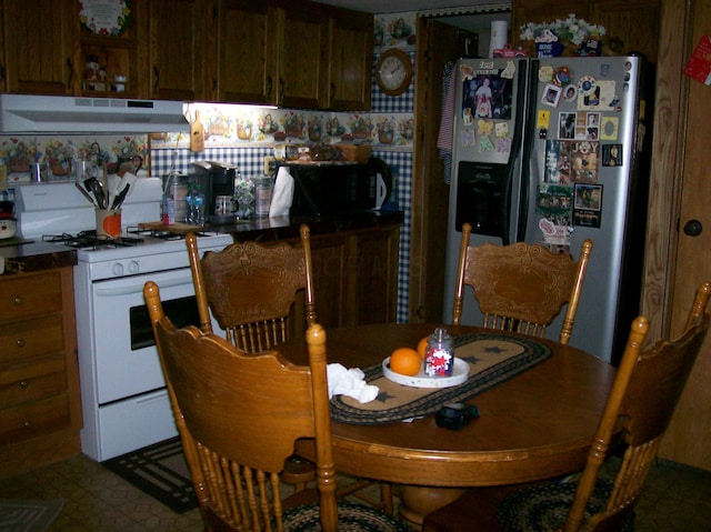258 Timberline Dr, Circleville, OH 43113 - kitchen featuring fridge with ice dispenser, white gas stove, under cabinet range hood, black microwave, and tile patterned floors