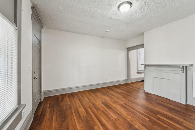 112 S Cypress Ave, Columbus, OH 43222 - unfurnished living room featuring wood finished floors, a textured ceiling, and baseboards