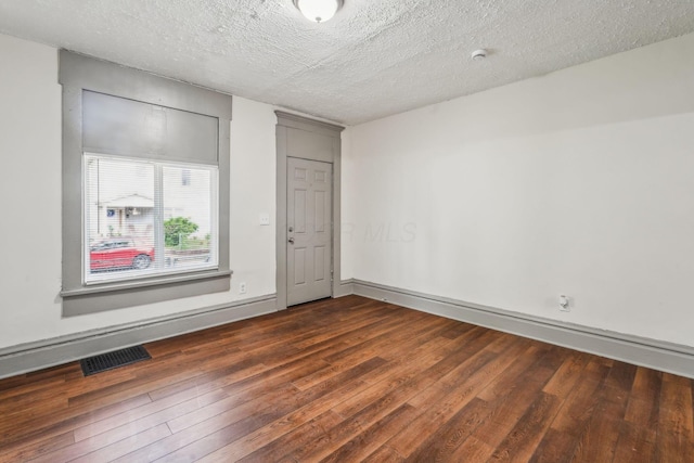 112 S Cypress Ave, Columbus, OH 43222 - spare room with dark wood-style floors, a textured ceiling, baseboards, and a smoke detector