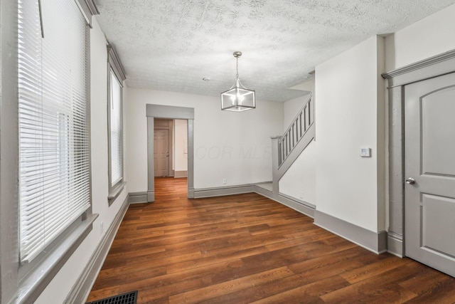 112 S Cypress Ave, Columbus, OH 43222 - unfurnished dining area featuring wood finished floors, a textured ceiling, baseboards, and stairway