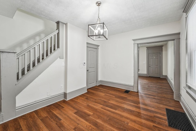 112 S Cypress Ave, Columbus, OH 43222 - unfurnished dining area featuring a chandelier, dark wood-style floors, a textured ceiling, baseboards, and stairway