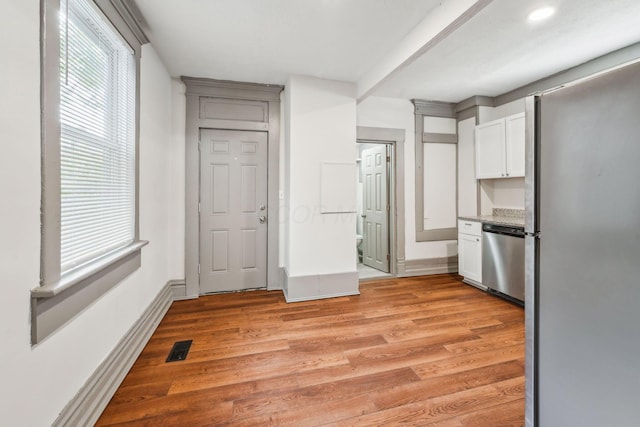 112 S Cypress Ave, Columbus, OH 43222 - kitchen with appliances with stainless steel finishes, light wood-style floors, white cabinets, and plenty of natural light