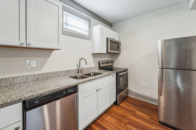 112 S Cypress Ave, Columbus, OH 43222 - kitchen with appliances with stainless steel finishes, a sink, light stone countertops, and white cabinets