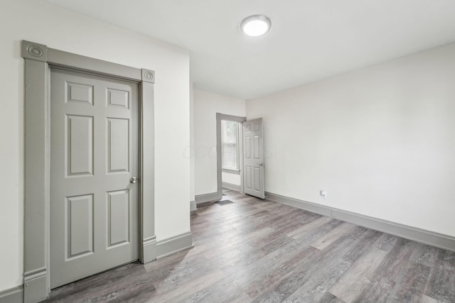 112 S Cypress Ave, Columbus, OH 43222 - unfurnished bedroom with wood finished floors and baseboards