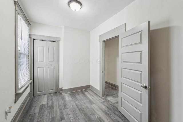 112 S Cypress Ave, Columbus, OH 43222 - unfurnished bedroom featuring wood finished floors, a closet, and baseboards