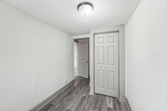 112 S Cypress Ave, Columbus, OH 43222 - unfurnished bedroom with wood finished floors, baseboards, and a closet