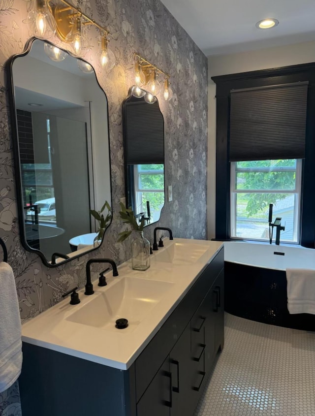 1217 Franklin Ave, Columbus, OH 43205 - bathroom with double vanity, a soaking tub, wallpapered walls, and tile patterned flooring
