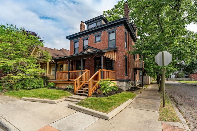1217 Franklin Ave, Columbus, OH 43205 - american foursquare style home featuring a chimney, brick siding, and a porch