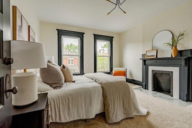 1217 Franklin Ave, Columbus, OH 43205 - bedroom with a fireplace, marble finish flooring, and a chandelier