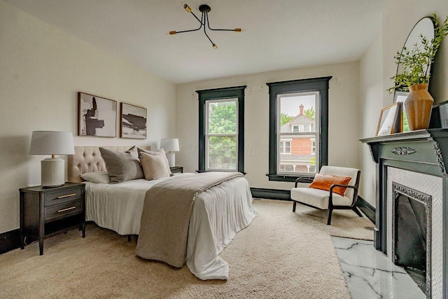 1217 Franklin Ave, Columbus, OH 43205 - carpeted bedroom featuring a fireplace with flush hearth, a chandelier, and baseboards