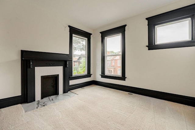 1217 Franklin Ave, Columbus, OH 43205 - unfurnished living room featuring a tiled fireplace, carpet floors, and baseboards
