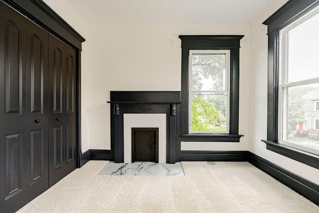 1217 Franklin Ave, Columbus, OH 43205 - living area with a tile fireplace, plenty of natural light, carpet flooring, and baseboards