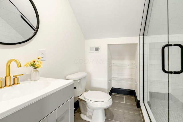 1217 Franklin Ave, Columbus, OH 43205 - bathroom with lofted ceiling, a shower stall, toilet, tile patterned floors, and vanity