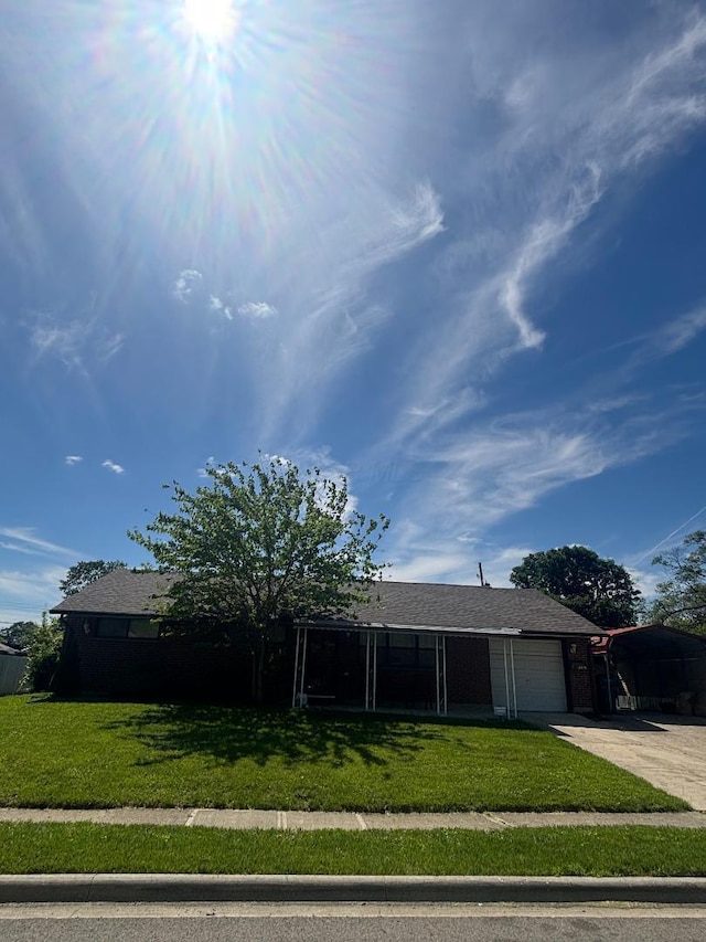 909 Stephen Dr W, Columbus, OH 43204 - ranch-style home with a front yard, a garage, and concrete driveway