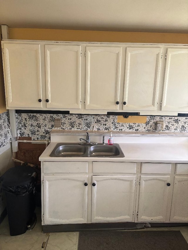 909 Stephen Dr W, Columbus, OH 43204 - kitchen with a sink, white cabinetry, and light countertops