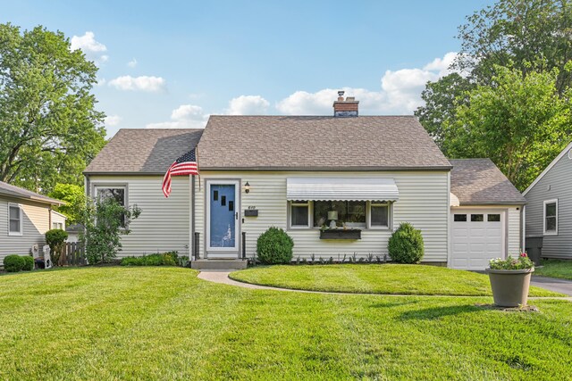640 Wetmore Rd, Columbus, OH 43214 - new england style home with a chimney, a front yard, driveway, and a shingled roof