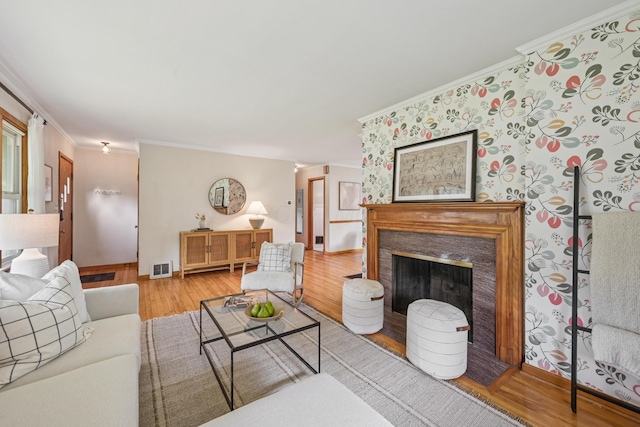 640 Wetmore Rd, Columbus, OH 43214 - living room with ornamental molding, wood finished floors, and a fireplace