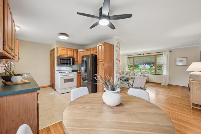 640 Wetmore Rd, Columbus, OH 43214 - dining space with ceiling fan, light wood-type flooring, and baseboards