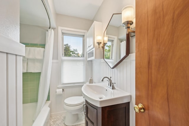 640 Wetmore Rd, Columbus, OH 43214 - full bath featuring vanity, toilet, a wainscoted wall, shower / bathtub combination with curtain, and tile patterned floors