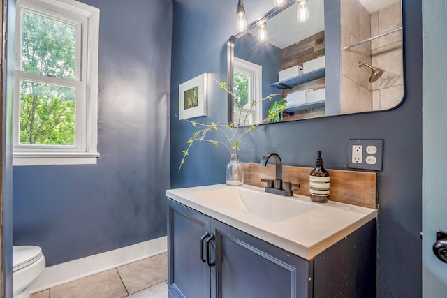 976 Oakwood Ave, Columbus, OH 43206 - bathroom with tile patterned floors, vanity, toilet, and healthy amount of natural light