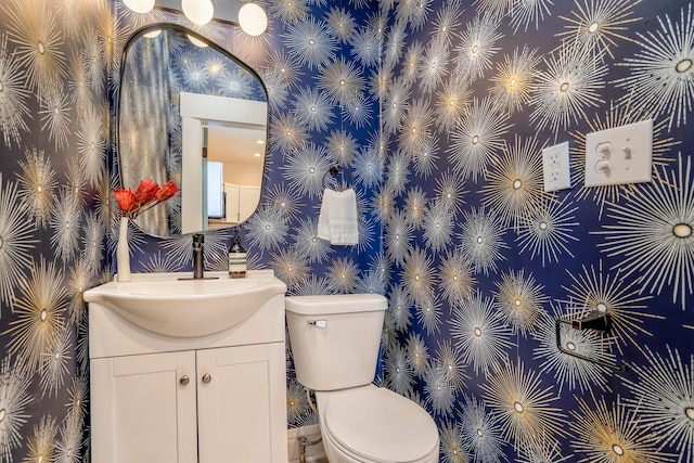 976 Oakwood Ave, Columbus, OH 43206 - half bathroom featuring vanity, wallpapered walls, and toilet