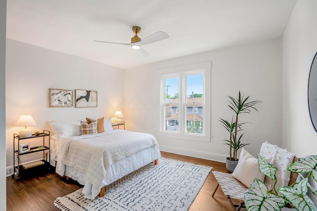 976 Oakwood Ave, Columbus, OH 43206 - bedroom featuring baseboards, wood finished floors, and a ceiling fan