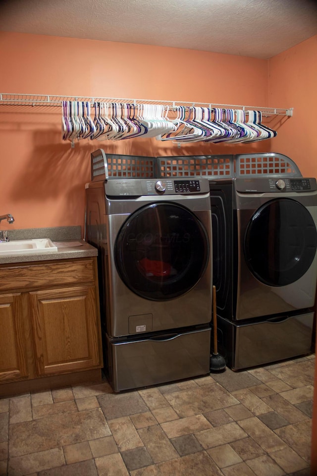 350 S Houston Pike, South Vienna, OH 45369 - laundry room featuring independent washer and dryer, stone tile flooring, and cabinet space