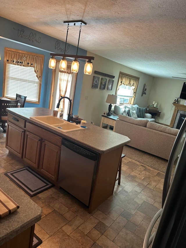 350 S Houston Pike, South Vienna, OH 45369 - kitchen featuring dishwasher, a sink, plenty of natural light, a center island with sink, and a textured ceiling