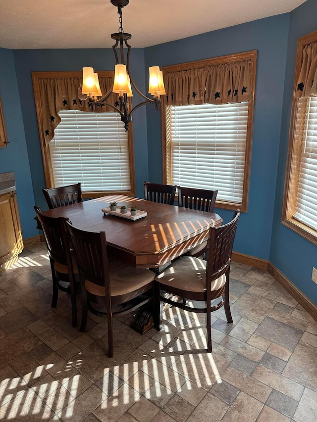 350 S Houston Pike, South Vienna, OH 45369 - dining area with a chandelier, baseboards, and stone tile floors